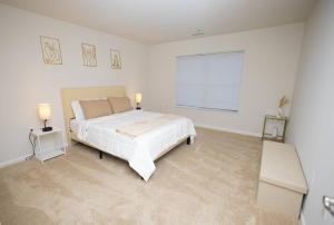 a white bedroom with a large bed and a window at Perfect Stay! 1 BR mins to DC in Arlington