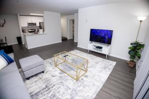 a living room with a television and a coffee table at Perfect Stay! 1 BR mins to DC in Arlington