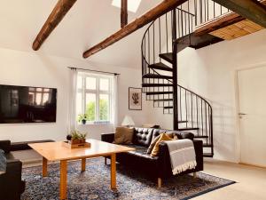 a living room with a couch and a table at Fantastic farm holiday in Ebeltoft