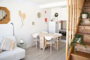 a small kitchen and dining room with a table and chairs at Duplex OverTheTejo, 5 min Belém Tower in Lisbon +25 photos