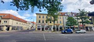 a city street with cars parked in front of buildings at 3 Zimmer - Ferien & Monteur Maisonette in Magdeburg, H in Magdeburg