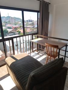 a living room with a couch and a table and a balcony at Loft Las Piedras in Torres