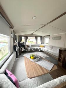 a rv living room with a couch and a table at Seton Sands Holiday Village Klover in Port Seton
