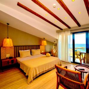 a bedroom with a bed with a view of the ocean at Villa Siesta Hotel Istanbul Airport in Karaburun