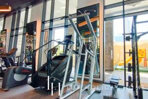 a gym with a treadmill in front of a window at LUX The Elegant DIFC Suite in Dubai