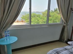 a bedroom with a window with a view of the ocean at BleVaMa Ocean View Home in Dar es Salaam
