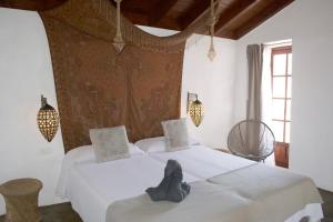 a bedroom with two beds with shoes on them at Casa Los Llanos in Playa de Santiago