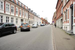 a street with cars parked on the side of the road at (id115) Nørregade 51 kl in Esbjerg