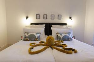 a stuffed octopus is on a bed at The Lookout - Stylish penthouse with sea views in Kent