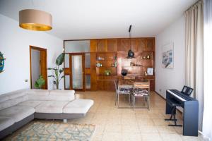 a living room with a couch and a table at Panoramic Ocean view in Puerto de Santiago