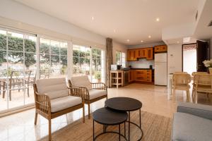 a kitchen and living room with a couch and a table at Charming two bedroom house close to the sea in Marbella