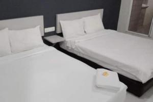 Postel nebo postele na pokoji v ubytování Hotel Global Sungai Way