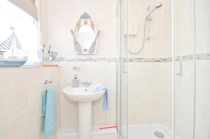 a bathroom with a sink and a shower at 36 Sandown Bay Holiday Centre in Brading