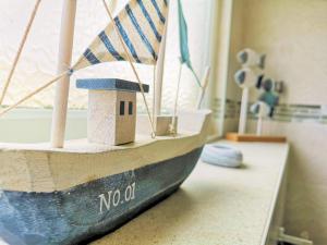 a wooden boat sitting on a counter with a toy ship at 36 Sandown Bay Holiday Centre in Brading