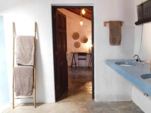 a bathroom with a blue sink and a wooden door at Casa Los Llanos in Playa de Santiago +23 photos