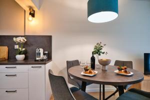 a kitchen and dining room with a table and chairs at Laguna Beskidów Resort - Apartament A83 in Zarzecze