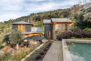 a home with a swimming pool and a house at VIVA Douro Countryside Lodge in Cinfães