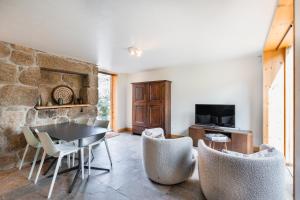 a living room with a table and chairs at VIVA Douro Countryside Lodge in Cinfães