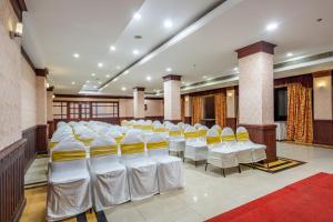 a room with a bunch of chairs in it at Daan Orchid Residency in Kottayam