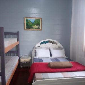 a bedroom with two bunk beds and a red blanket at Pousada Maranata B&B in Paranapiacaba