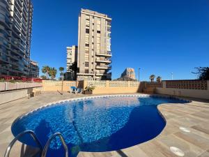 duży niebieski basen z wysokim budynkiem w tle w obiekcie Amazing sea views Amatista 10 w mieście Calpe