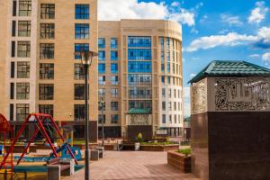 a playground in front of a large building at Апартаменты возле ЭКСПО in Astana