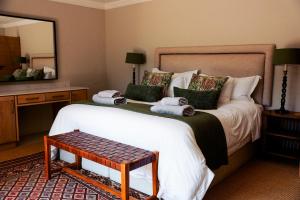 a bedroom with a large bed with towels on it at Summerplace Game Reserve in Vaalwater