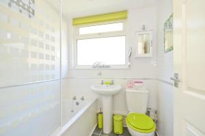 a bathroom with a green toilet and a sink at 74 Sandown Bay Holiday Park, Isle of Wight in Sandown
