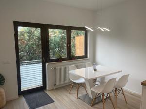 a white dining room with a white table and chairs at Appartment in Freizeitpark in Wiesloch