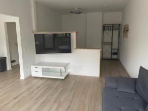 a living room with a couch and a flat screen tv at Appartment in Freizeitpark in Wiesloch