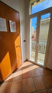 a room with a door and a balcony at Appartamenti Fiore 2.0 in Sanremo
