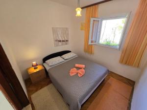 a small bedroom with a bed and a window at Indy's Sunny Apartment in Dubrovnik