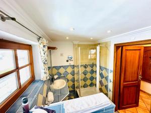 a bathroom with a tub and a sink and a shower at Gästehaus Bühler in Oberstdorf