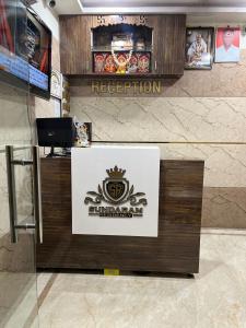 a reception desk in a building with a sign at Sundaram Residency in Chennai