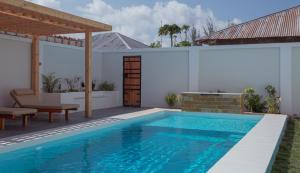 a swimming pool in the backyard of a house at Nebo Apartments Paje in Paje