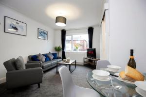 a living room with a couch and a table at HC Property - Cromwell Avenue in Newcastle upon Tyne