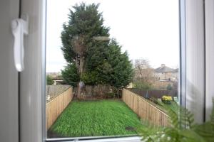 a view from a window of a yard with a fence at HC Property - Cromwell Avenue in Newcastle upon Tyne