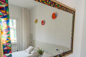 a mirror on the wall of a room with a bed at Maiori Apartment by Marcel in Maiori +53 photos