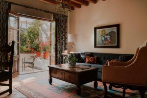 a living room with a couch and a coffee table at Casa de Sierra Nevada, A Belmond Hotel, San Miguel de Allende in San Miguel de Allende