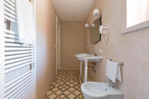 a bathroom with a toilet and a sink at Palazzo Fasti in Casarano