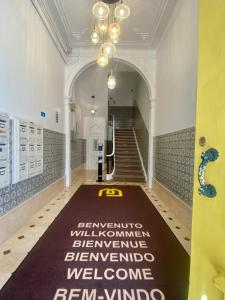 a hallway with a welcome mat on the floor at Studios with Mezzanine Rua da Moeda in Lisbon