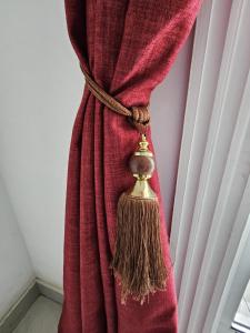 uma cortina vermelha com uma vassoura presa a ela em Octave's APT em Ponta Negra