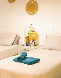 a white bed with a blue towel on it at Beautiful One Bedroom Ground Floor Apartment - VeraLuna in Tías