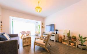 a living room with a couch and a chair at Beautiful One Bedroom Ground Floor Apartment - VeraLuna in Tías