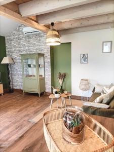 an open living room with a brick wall at Havre de Paix 40 in Pouillon