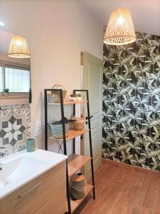 a kitchen with a sink and a wall with a pattern at Havre de Paix 40 in Pouillon