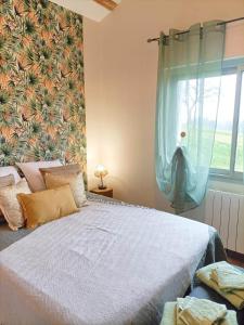 a bedroom with a large bed and a window at Havre de Paix 40 in Pouillon