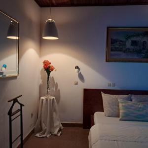 a bedroom with a vase of flowers on a table at Village NDJIKESSI in Yaoundé