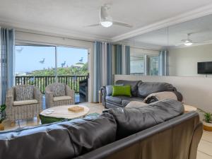 a living room with a couch and a table at 15 Praslin in Ramsgate