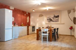 a kitchen and dining room with a table and chairs at BEACH HOUSE CASKA in Novalja